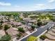 An aerial view showcases a well-planned community with lush green spaces and manicured lawns on a clear day at 16861 W Ironwood St, Surprise, AZ 85388