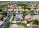 A beautiful aerial view displays homes with backyard pools,solar panels, lush landscaping, and well-kept yards at 16861 W Ironwood St, Surprise, AZ 85388