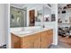 Bathroom with double vanity, framed mirrors, and a glass-enclosed shower with custom tiling at 16861 W Ironwood St, Surprise, AZ 85388
