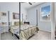 Bedroom features a four-poster bed, neutral tones, and a window with natural light at 16861 W Ironwood St, Surprise, AZ 85388