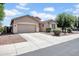 Charming single-story home featuring a two-car garage and a low-maintenance landscaped yard at 16861 W Ironwood St, Surprise, AZ 85388
