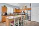 Bright kitchen features a center island with seating, stainless steel appliances, and ample cabinet space at 16861 W Ironwood St, Surprise, AZ 85388