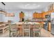 Bright kitchen featuring an island with seating, stainless steel appliances, and stylish backsplash at 16861 W Ironwood St, Surprise, AZ 85388
