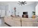 Bright living area boasts light blue walls, tile flooring, and cozy furnishings under a stylish ceiling fan at 16861 W Ironwood St, Surprise, AZ 85388