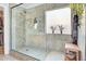 Walk-in shower with glass door, patterned tile, and built-in niche at 16861 W Ironwood St, Surprise, AZ 85388