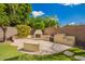Outdoor living space with a custom outdoor fireplace, built-in seating, and lush landscaping at 2018 E Avenida Del Sol --, Phoenix, AZ 85024
