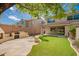 Well-maintained backyard with a custom outdoor fireplace, lush landscaping, and ample privacy at 2018 E Avenida Del Sol --, Phoenix, AZ 85024