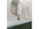 Stylish powder room with a green vanity, white countertop, a gold faucet, and a decorative mirror at 2018 E Avenida Del Sol --, Phoenix, AZ 85024