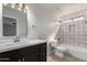 Bright bathroom with updated fixtures, dark cabinets, and shower over tub at 2018 E Avenida Del Sol --, Phoenix, AZ 85024