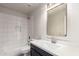 Modern bathroom featuring white subway tile in shower and dark vanity with marble countertop at 2018 E Avenida Del Sol --, Phoenix, AZ 85024