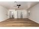 Large bedroom with wood floors, ceiling fan, and multiple doors leading to other rooms at 2018 E Avenida Del Sol --, Phoenix, AZ 85024