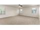 Spacious bedroom with neutral tones, plush carpet, lots of natural light, and a ceiling fan at 2018 E Avenida Del Sol --, Phoenix, AZ 85024