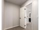 Hallway view of an open door to a bathroom with black cabinets and tile flooring at 2018 E Avenida Del Sol --, Phoenix, AZ 85024