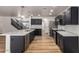 Updated kitchen boasts black cabinets, stainless appliances, light countertops, and an eat-in kitchen island at 2018 E Avenida Del Sol --, Phoenix, AZ 85024