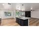 Modern kitchen flows into a spacious living area, featuring a large island and stainless steel appliances at 2018 E Avenida Del Sol --, Phoenix, AZ 85024