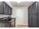 Well-organized laundry room with modern washer and dryer, abundant gray storage cabinets, and convenient access door at 2018 E Avenida Del Sol --, Phoenix, AZ 85024