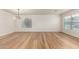 A spacious living room featuring hardwood floors, two large windows for natural lighting, and a modern light fixture at 2018 E Avenida Del Sol --, Phoenix, AZ 85024