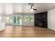 Living room with wood floors and a fireplace, with open access to the kitchen and views of the back yard at 2018 E Avenida Del Sol --, Phoenix, AZ 85024