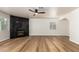 Spacious living room with a ceiling fan, hardwood flooring, and a sleek black marble fireplace for cozy evenings at 2018 E Avenida Del Sol --, Phoenix, AZ 85024