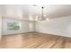 Bright, spacious living area featuring hardwood floors, stylish light fixture, and neutral walls at 2018 E Avenida Del Sol --, Phoenix, AZ 85024
