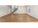 Open living room with hardwood floors, modern light fixture, and a staircase for a functional design at 2018 E Avenida Del Sol --, Phoenix, AZ 85024