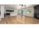 Bright, open-concept living space features wood floors, modern black cabinets and a fireplace with sliding glass doors at 2018 E Avenida Del Sol --, Phoenix, AZ 85024