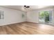 Spacious living room featuring new wood floors, a ceiling fan, and a sliding door to the backyard at 2018 E Avenida Del Sol --, Phoenix, AZ 85024