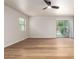 Bright living room with wood floors, ceiling fan, and a glass sliding door overlooking the pool at 2018 E Avenida Del Sol --, Phoenix, AZ 85024