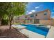 Sparkling pool featuring refreshing blue water and a serene backyard setting with mature trees and landscaping at 2018 E Avenida Del Sol --, Phoenix, AZ 85024
