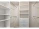 White walk-in closet with multiple shelves and drawers for organized storage at 2018 E Avenida Del Sol --, Phoenix, AZ 85024