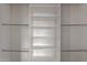 Spacious white walk-in closet with shelves and chrome hanging rods for ample storage at 2018 E Avenida Del Sol --, Phoenix, AZ 85024