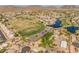 Expansive aerial view showcasing the community's golf course, lakes, and neatly arranged homes at 21335 N 64Th Ave, Glendale, AZ 85308