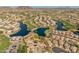 Gorgeous aerial view showcasing the community's winding lakes, lush golf course, and stunning mountain backdrop at 21335 N 64Th Ave, Glendale, AZ 85308