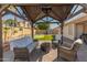 Backyard featuring a covered patio with wicker furniture, a putting green, and a shed at 21335 N 64Th Ave, Glendale, AZ 85308