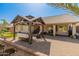 Backyard featuring a covered patio, pavers, turf, and easy-care landscaping at 21335 N 64Th Ave, Glendale, AZ 85308