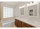 Elegant bathroom showcasing a double sink vanity, offering plenty of space and a serene atmosphere at 21335 N 64Th Ave, Glendale, AZ 85308