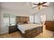 Spacious bedroom featuring vaulted ceiling, shuttered windows, and a view into the bathroom at 21335 N 64Th Ave, Glendale, AZ 85308