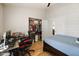 A bedroom with light wood flooring, a closet and an open ensuite at 21335 N 64Th Ave, Glendale, AZ 85308