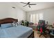 Comfortable bedroom featuring a ceiling fan, window shutters, and wood-look flooring at 21335 N 64Th Ave, Glendale, AZ 85308