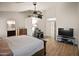 A well-lit bedroom, complete with warm-toned hardwood floors and connections to a bathroom and closet at 21335 N 64Th Ave, Glendale, AZ 85308