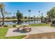 Scenic view of the community amenities, including a lake, a golf course, and a peaceful picnic area at 21335 N 64Th Ave, Glendale, AZ 85308