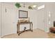 Bright entryway features a hardwood floor, mirror, and front door at 21335 N 64Th Ave, Glendale, AZ 85308