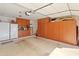 Spacious garage with ample storage cabinets and plenty of room for parking and organization at 21335 N 64Th Ave, Glendale, AZ 85308