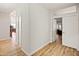Inviting hallway with wood floors leading to various rooms of the home at 21335 N 64Th Ave, Glendale, AZ 85308