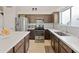 Bright kitchen boasting granite countertops, stainless steel appliances, and ample storage space at 21335 N 64Th Ave, Glendale, AZ 85308