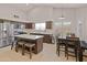 Well-equipped kitchen with a central island, stainless steel appliances, and an adjacent dining space at 21335 N 64Th Ave, Glendale, AZ 85308