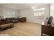 Cozy living room with hardwood floors, warm lighting, and lots of natural light from the windows at 21335 N 64Th Ave, Glendale, AZ 85308