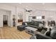 Open living area featuring hardwood floors, a view into the kitchen, and lots of natural light at 21335 N 64Th Ave, Glendale, AZ 85308