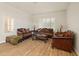 Bright living room featuring hardwood floors, warm lighting, and traditional furniture at 21335 N 64Th Ave, Glendale, AZ 85308