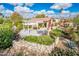 Aerial view of a beautiful home with a lush backyard, patio, and meticulously manicured landscaping at 22633 N Clubhouse Way, Scottsdale, AZ 85255